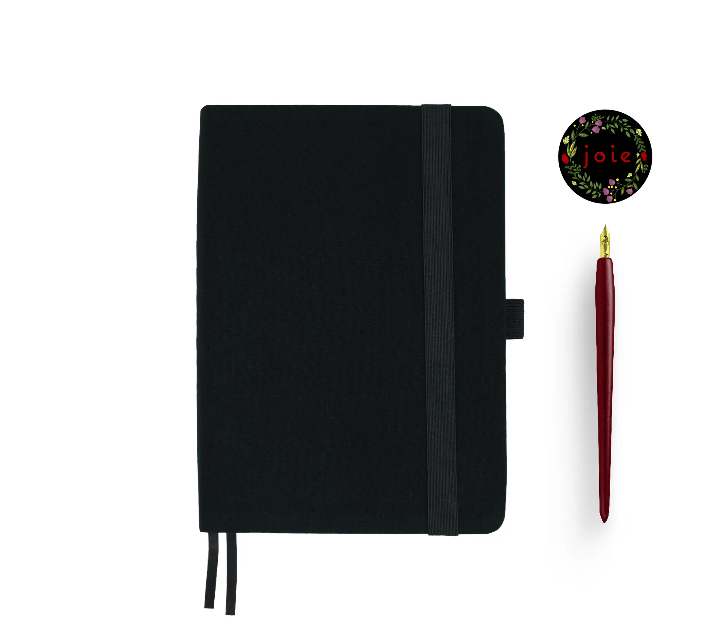 Black fabric-covered notebook with rounded corners, matching black elastic band, pen loop, and dual ribbon bookmarks, displayed with a red fountain pen and a floral 'joie' logo